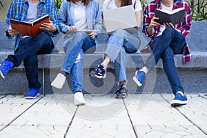 A group of high school students are studying together in the university. A gang of friends uses books, computers, tablets to learn