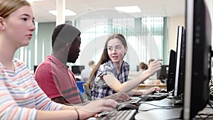 Group Of High School Students Working Together In Computer Class