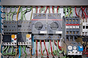 A group of electrical relays with connected wires.