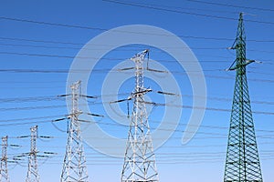 Group of high voltage towers under sky