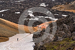 Group of hiker trekking on Landmannalaugar trail with volcanic lava during summer at Highlands of Iceland