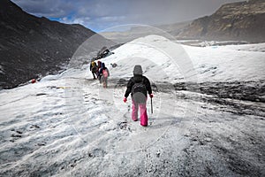 Group of hiker walk on glacier during heavy snow fall on Solheimajokull,