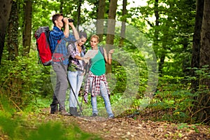 Group of hikers searching right direction