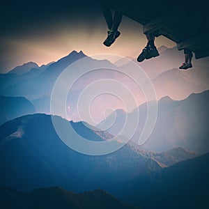 Group of hikers sit above the mountain. Instagram stylisation