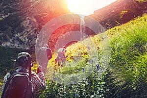 Group Of Hikers Tourists Walking Uphill To Waterfall. Travel Adventure Outdoor Concept