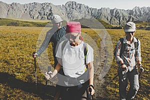 Group Of Hikers Walking Along The Plain In Summer Mountains, Journey Travel Trek Concept