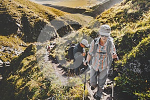 Group Of Hikers Walking Along In Summer Mountains, Journey Travel Trek Concept