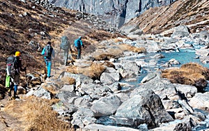 Group of Hikers walking on Footpath in Mountains rear View