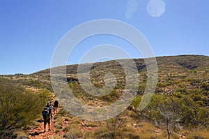 a group of Hikers on the way to the top of Mount Sonder just outside Alice Springs, West MacDonnel National Park, Australia