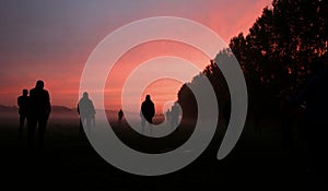 Group on hillside at sunset