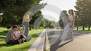 Group of hipsters teenagers having fun in park on road, teenage girl dancing street dance