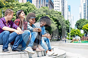 Group of hispanic and african american hipster young adults in the city