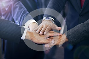 Group of hispanic business people joining hands