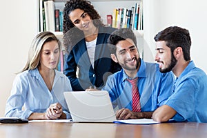 Group of hispanic business team at computer