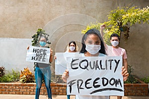 A group of Hispanic youths at a protest holding signs
