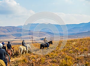 Group of Horseback riders on a trail in Drakensberg mountains