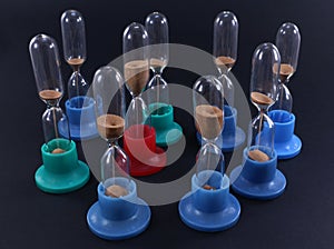 Group of hourglasses of different colors in action