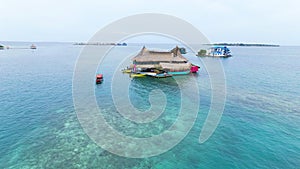 Group of houses floating in the sea on Tintipan Island in the San Bernardo Archipelago, Colombia