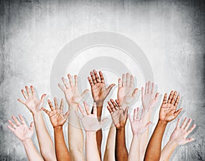 Group of Human Arms Raised with Concrete wall