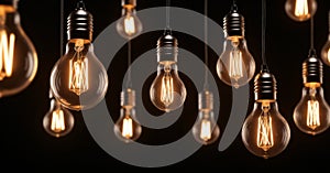 Group of incandescent light bulbs on black background