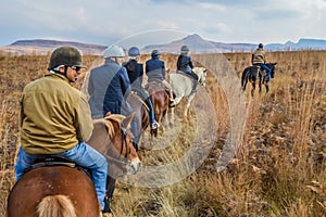 Group of Indian Horse riding riders on a trail in Drakensberg re