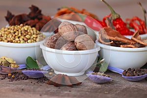 Group of indian spices and herbs difference ware on Wooden teblet,Different spices in spoons on table,Indian bay leaf, Garam photo