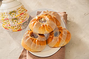 Group of individual pies with meat and potato - vak balish. Tatar traditional pies. White stone background. Close up and copy spa