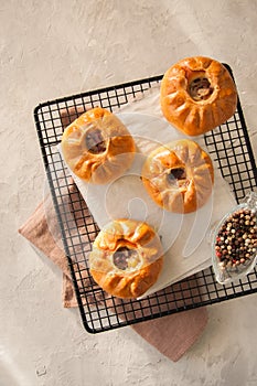 Group of individual pies with meat and potato - vak balish. Tatar traditional pies. White stone background. Top view.