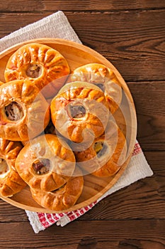 Group of individual pies with meat and potato - vak balish. Tatar traditional pies. Wooden background. Top view.