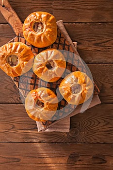 Group of individual pies with meat and potato - vak balish. Tatar traditional pies. Wooden background. Top view.