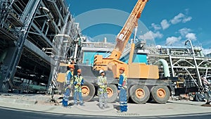 Group of indusrial workers talking at a building site. Industrial scene background