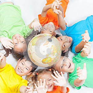 Group of international funny kids with globe earth