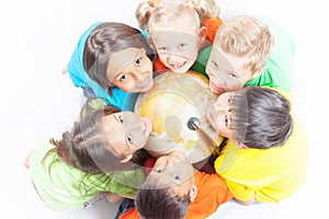 Group of international kids holding globe earth