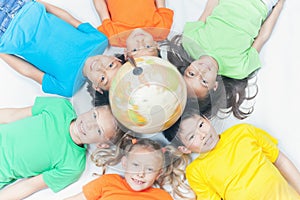 Group of international kids holding globe earth