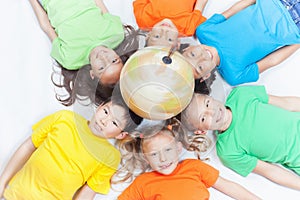 Group of international kids holding globe earth