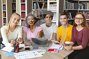 Group of international studying teenagers smiling at camera