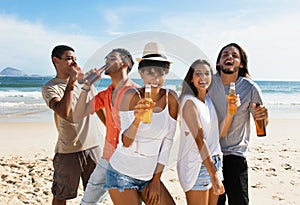 Group of international young adults celebrating at beach