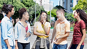 Group of international young adults in discussion in city