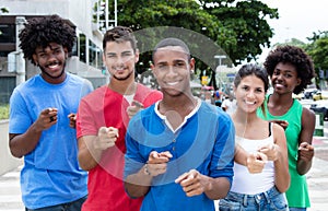 Group of international young adults pointing at camera