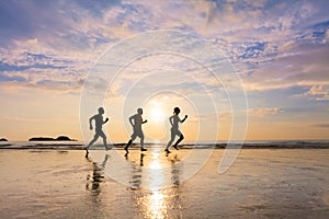 Group of joggers running on a beach, healthy lifestyle, sport photo