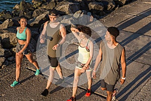 Group of joggers talking and smiling during workout