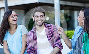 Group of joking young adult men and woman