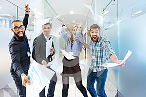 Group of joyful excited business people having fun in office