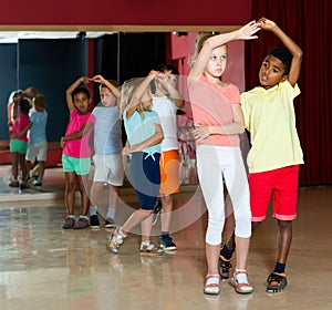 Group of joyful kids dancing salsa dance