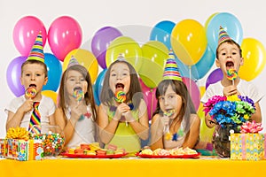 Group of joyful little kids having fun at birthday