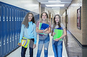 Group of Junior High school Students standing together in a school hallway photo