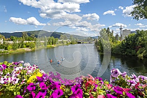 A group of kayakers under the Cedar St Bridge in Sandpoint, Idaho, on Lake Pend Oreille