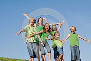 Group of kids arms raised or outstretched