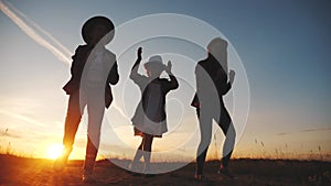 Group of kids dancing in the park silhouette lifestyle at sunset. kid dream party concept. children dancing in nature at