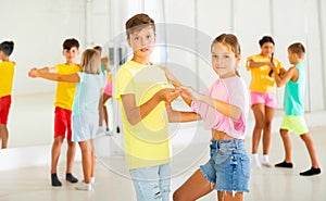 Group of kids dancing salsa in studio